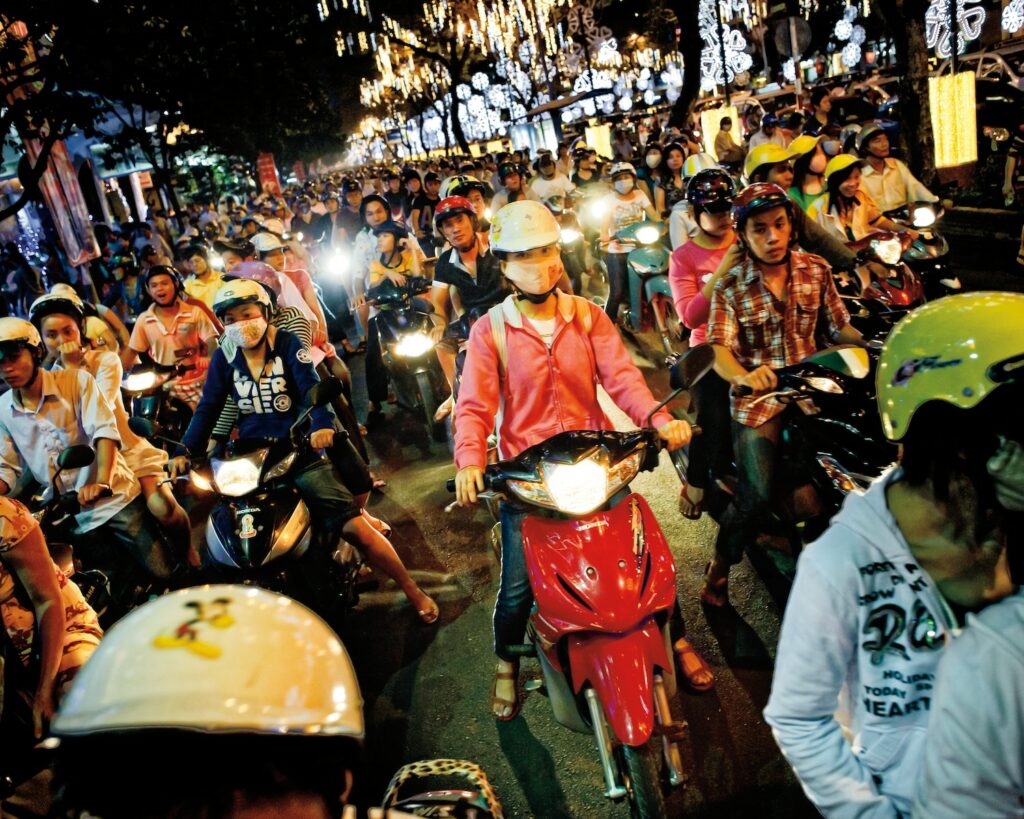 group of people riding a motorcycle Ho Chi Minh